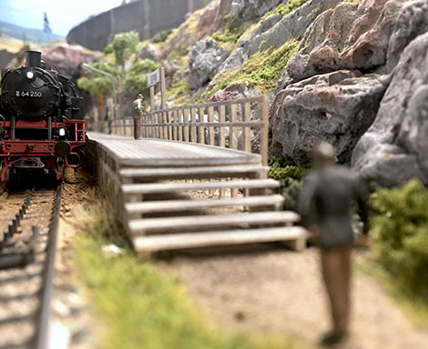 Rural stop featuring one track and a simple wooden platform 